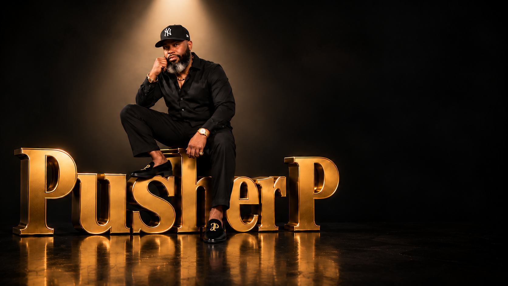 CJ, the Zi King, seated above the gold Pusher P sculpture